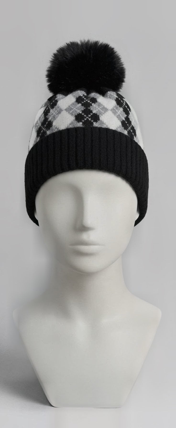 Black and white argyle pom pom beanie on mannequin