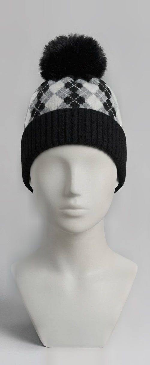 Black and white argyle pom pom beanie on mannequin