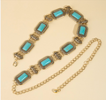 Gold turquoise rectangle concho chain belt on cream background