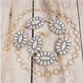 White turquoise concho chain belt on wood surface